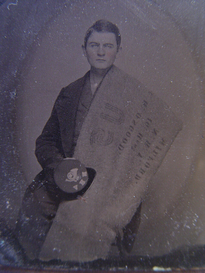 Private Charles H. Osgood of Company C, 16th New Hampshire Infantry Regiment with stenciled blanket and forage cap